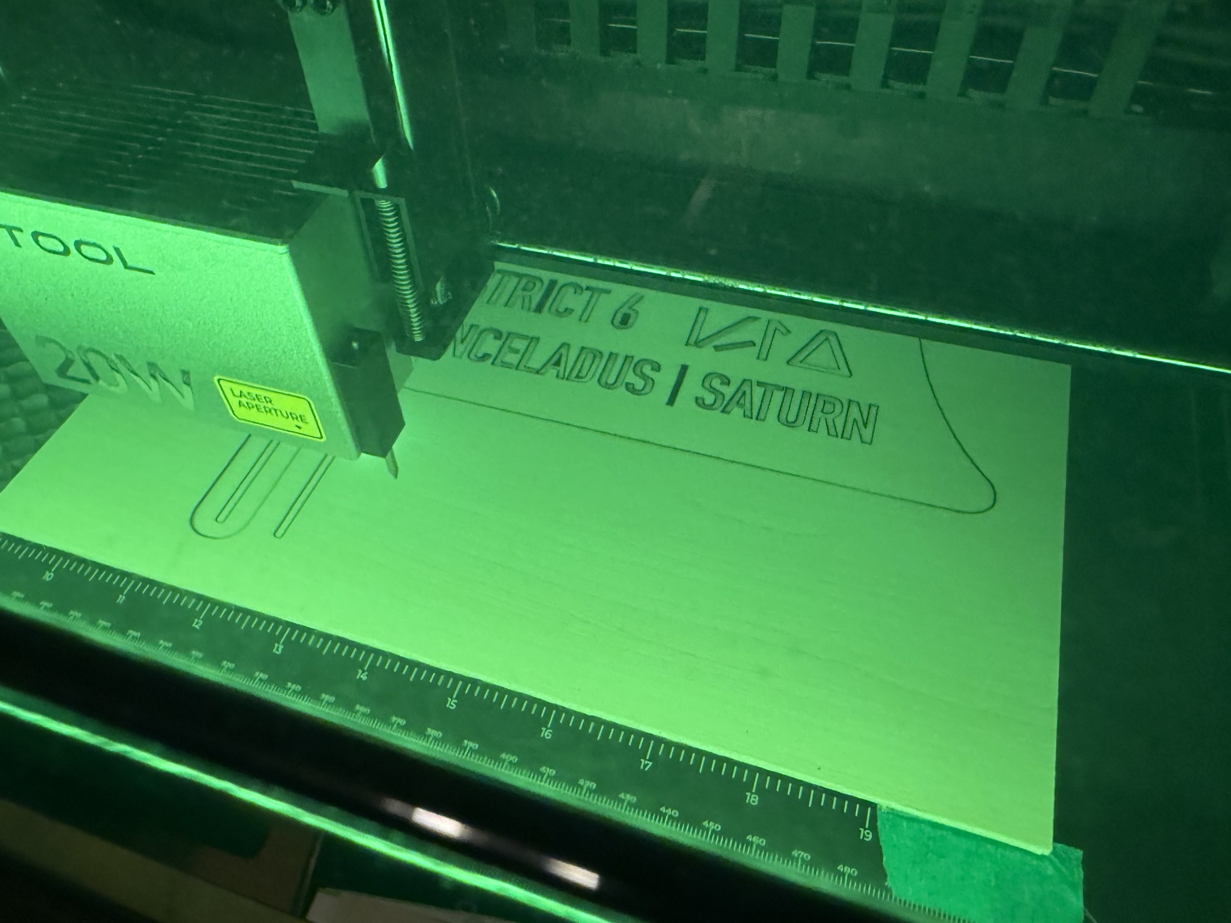 Outpost sign lettering being cut in the laser machine