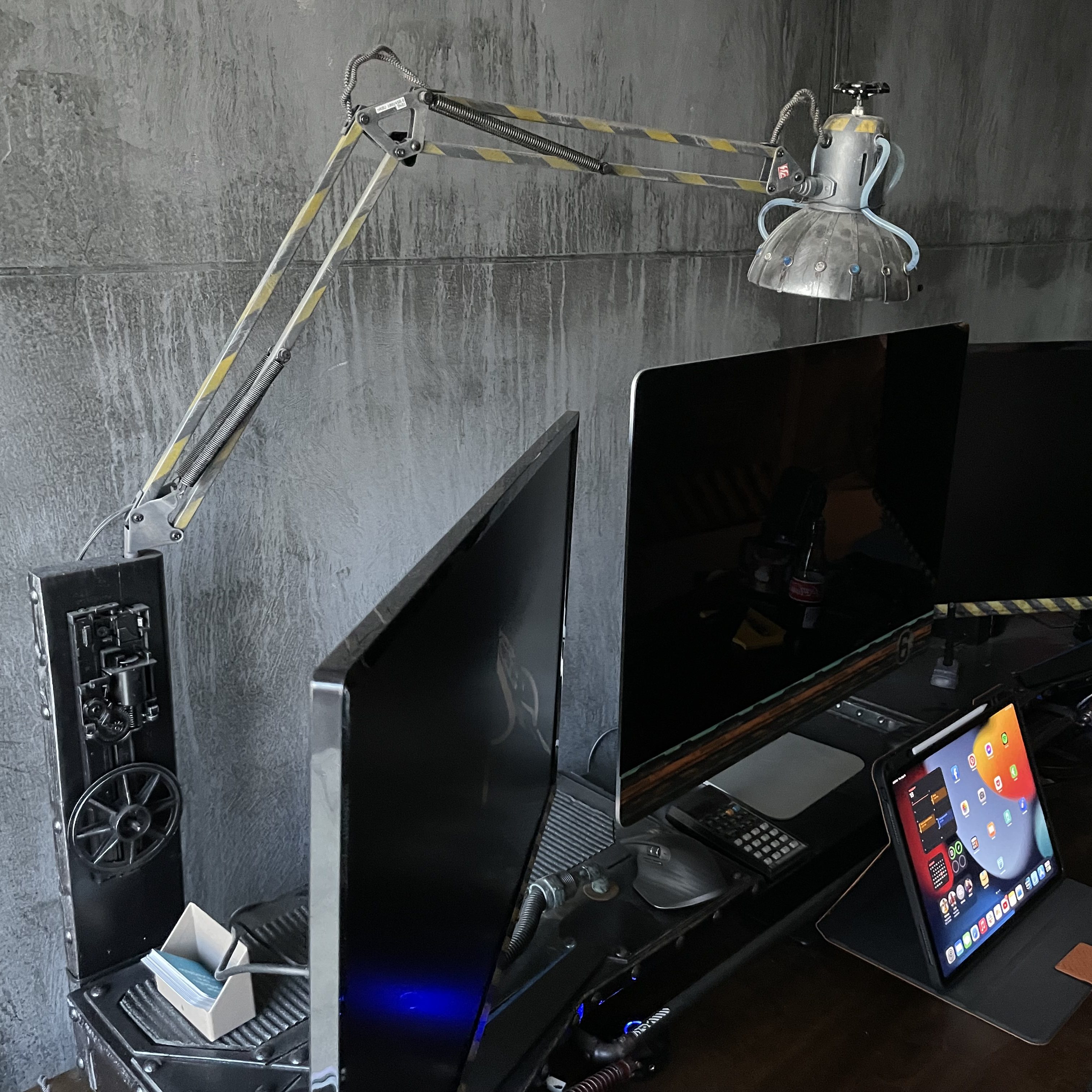 Repurposed industrial task lamp above Mick’s desk